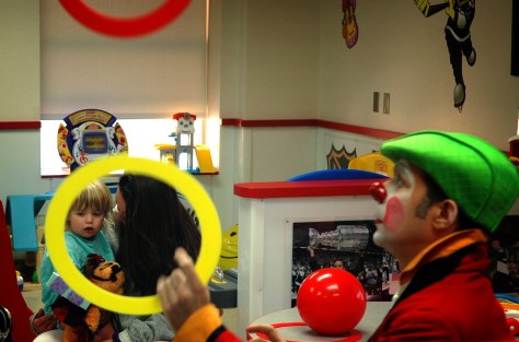 Dayla Baker, 2, and her mom watch as Bubu the clown juggles rings. Four clowns from the Ringling Bros and Barnum & Bailey Circus visited pediatric patients at Tampa General Hospital to brighten their day.