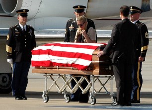 Mashelle Lembke stands over the casket of her husband U.S. Army Specialist Eric Lembke after his body was flown to MacDill Air Force Base in Tampa, Fla. for burial.